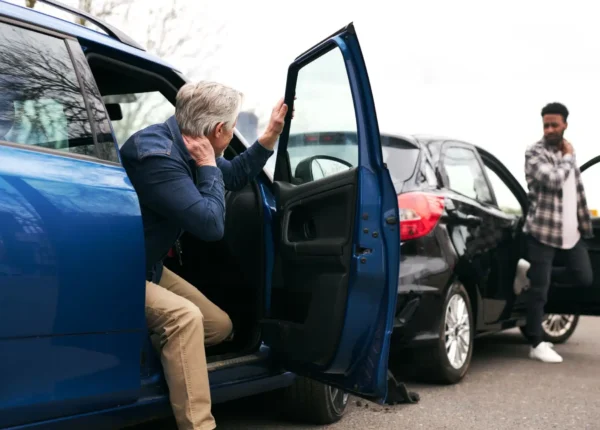 Two drivers getting out of their car after a car crash